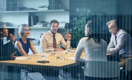 People in a meeting around a table
