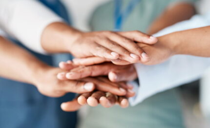 People with hands stacked